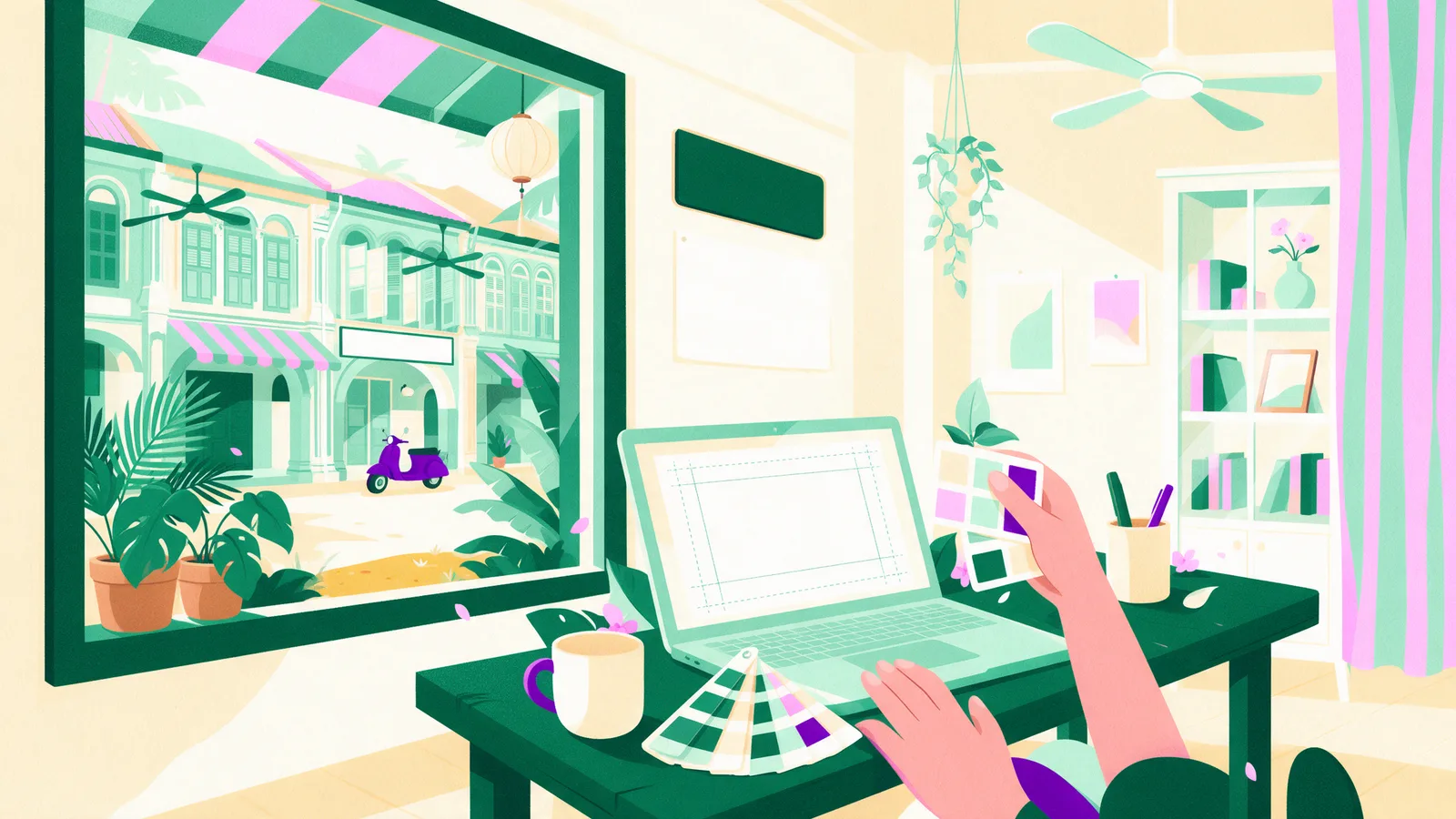 A designer laying out a magnet artwork on a laptop with a printed proof beside it